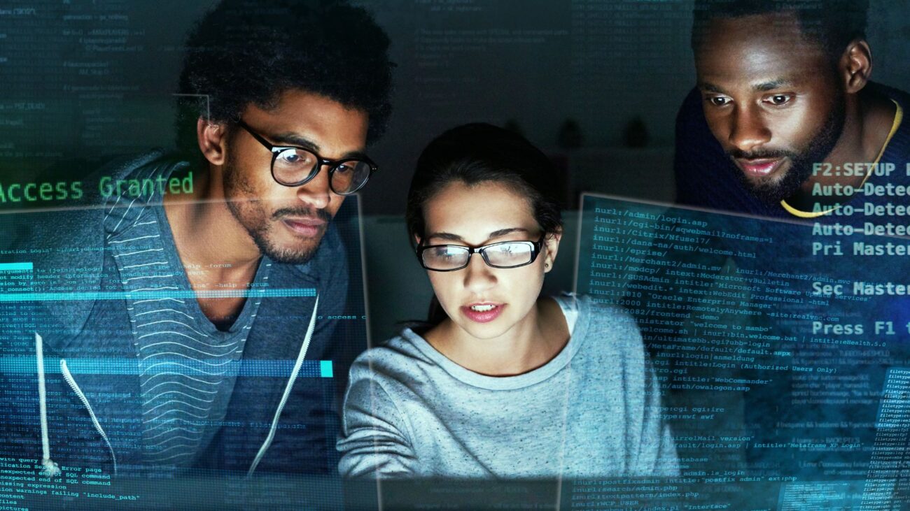 Three people looking at computer screens With a data overlay